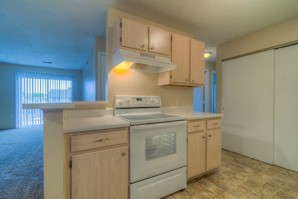 a kitchen with white appliances and wooden cabinets