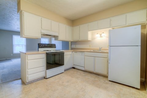 a kitchen with white cabinets and a stove and refrigerator