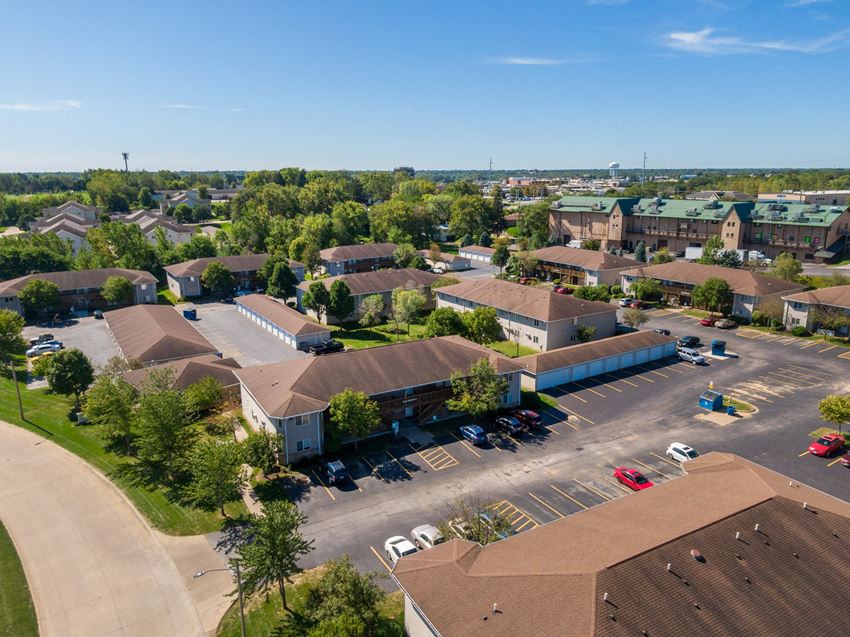 an aerial view of a neighborhood of houses with cars in a parking lot