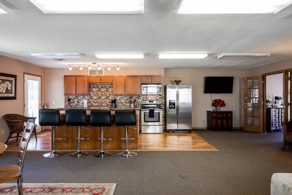 the kitchen is open to the living room with a bar