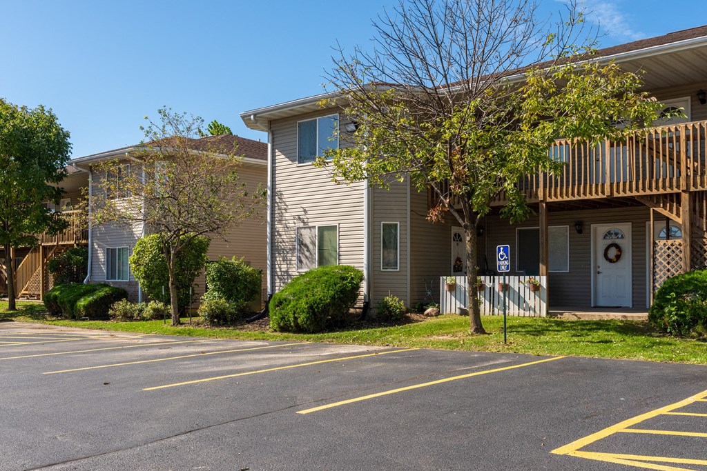 an apartment building with a parking lot and a street