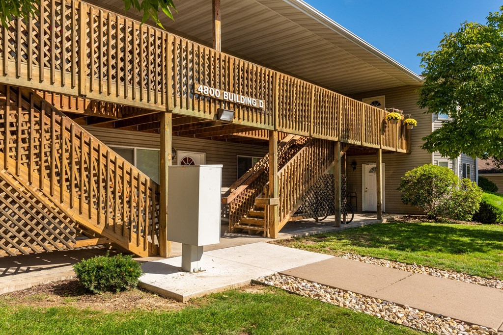the front of a building with stairs and a porch
