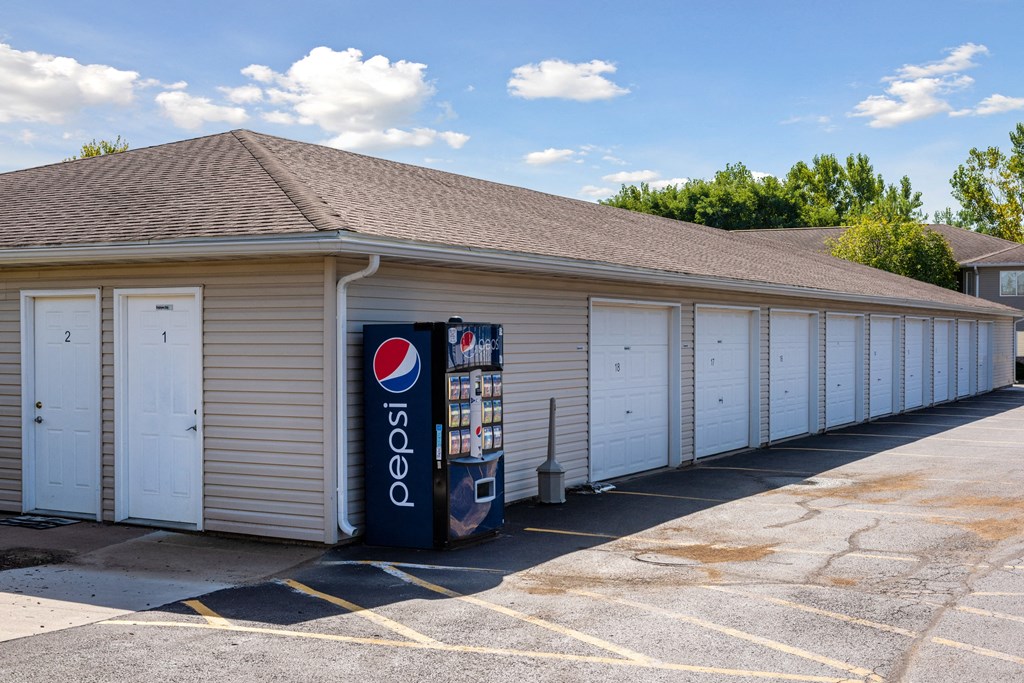 a gas station with a vending machine in front of it