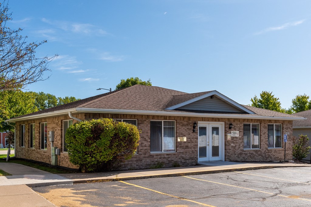the front of a brick building with a blue door