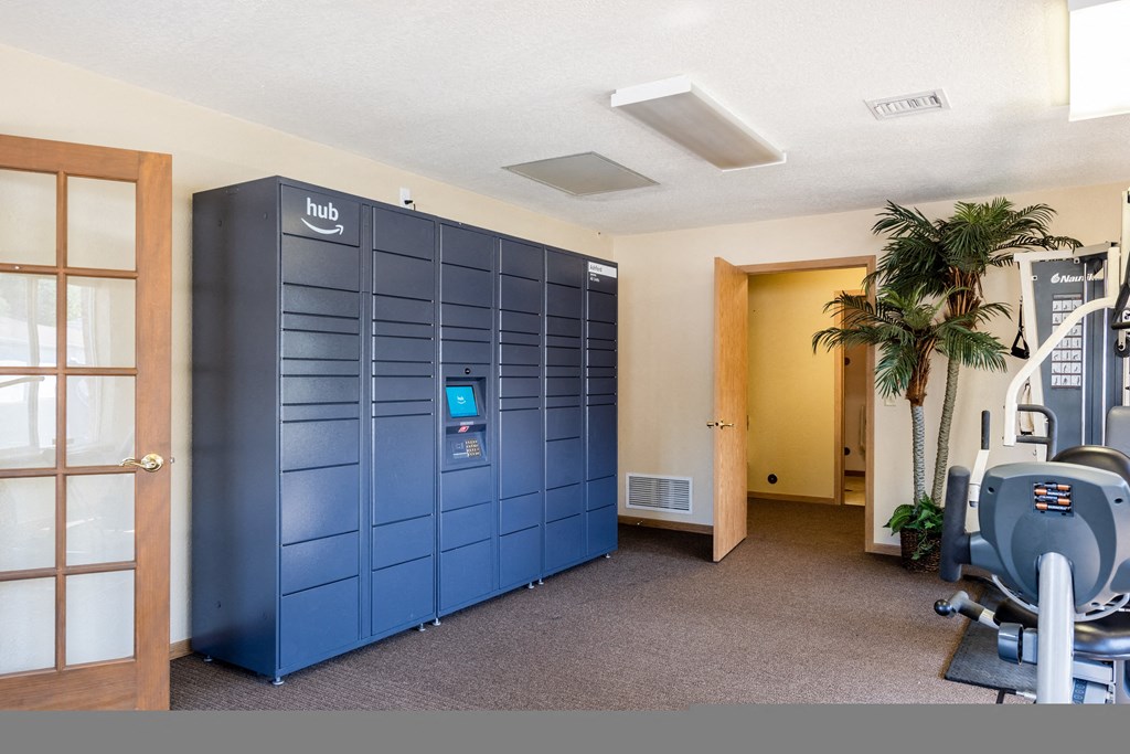a gym with a blue locker room and exercise equipment