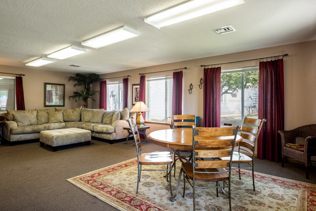 a living room with couches chairs and a table