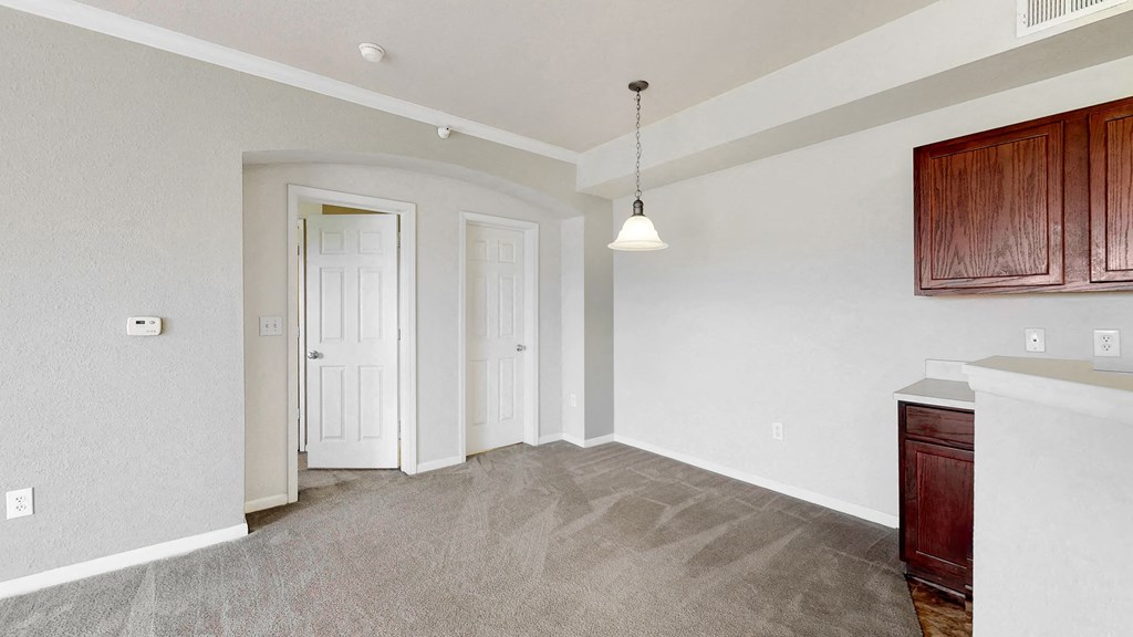 an empty living room with white walls and a white door