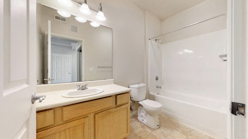 a bathroom with a sink toilet and a mirror