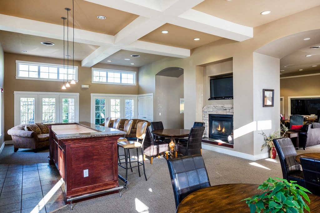 a living room with a bar and a fireplace