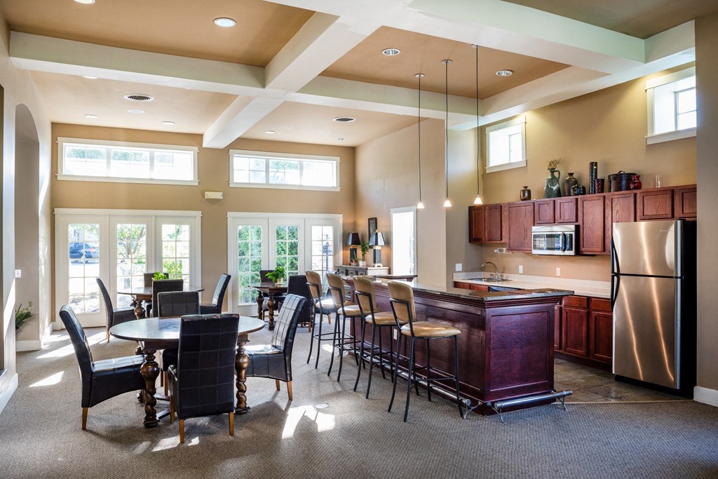 a dining room with a kitchen and a table and chairs