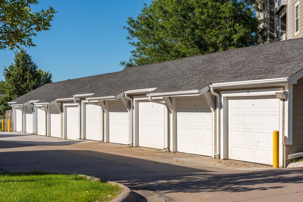 a row of white garage doors on a building