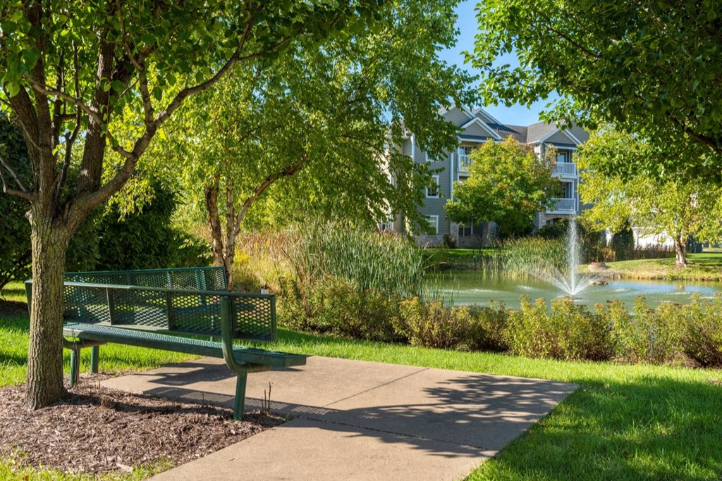 a park bench sitting next to a fountain