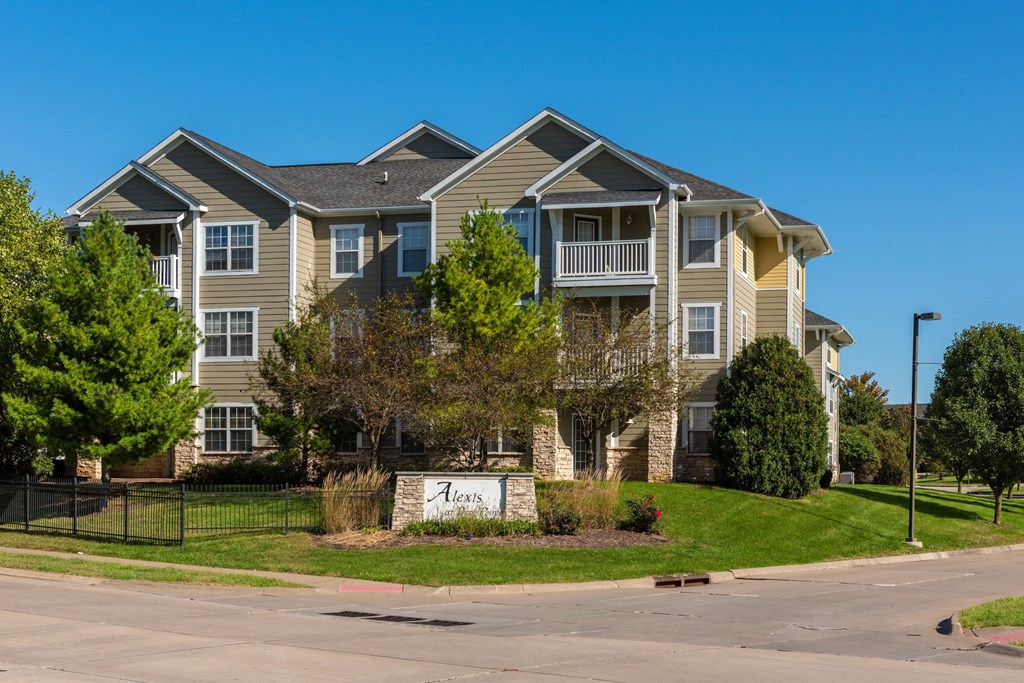 an apartment building with a street sign in front of it