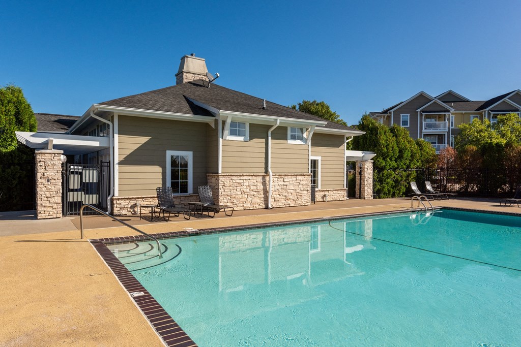 a swimming pool with a house in the background