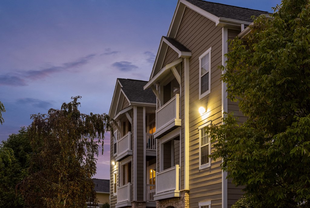 a row of town houses at dusk with trees