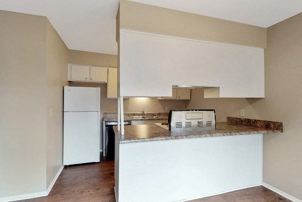 a kitchen with a counter top and a refrigerator