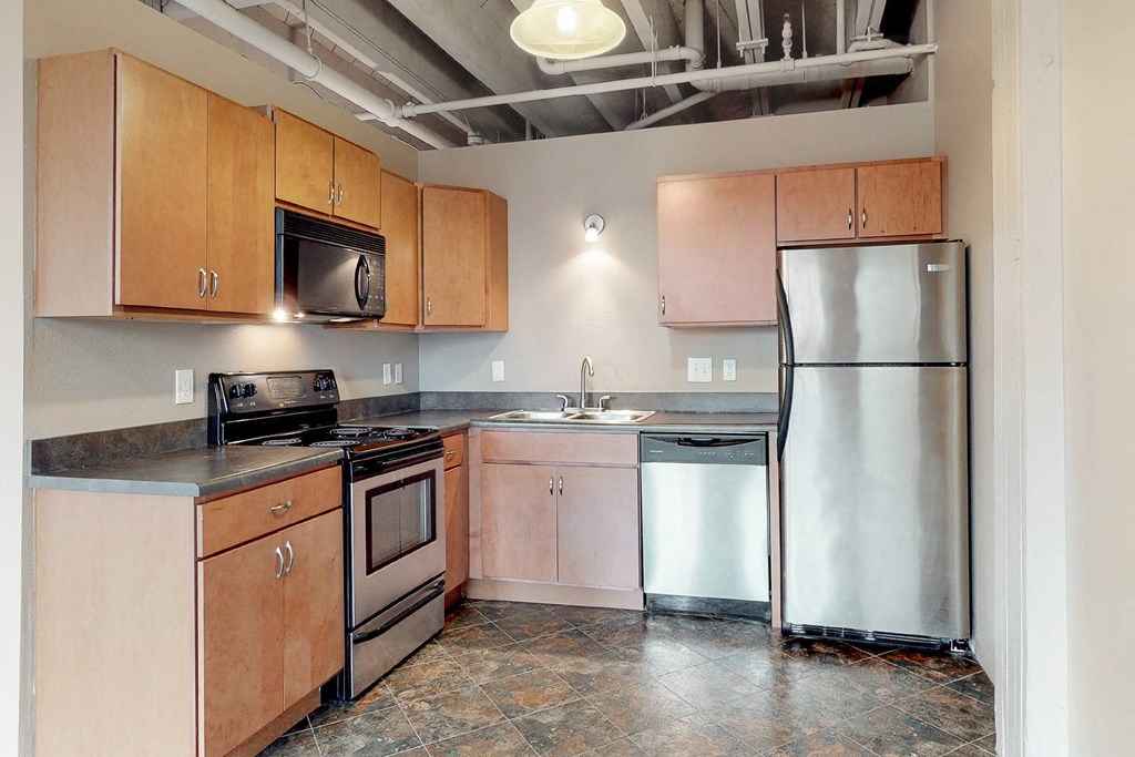 a kitchen with stainless steel appliances and wooden cabinets