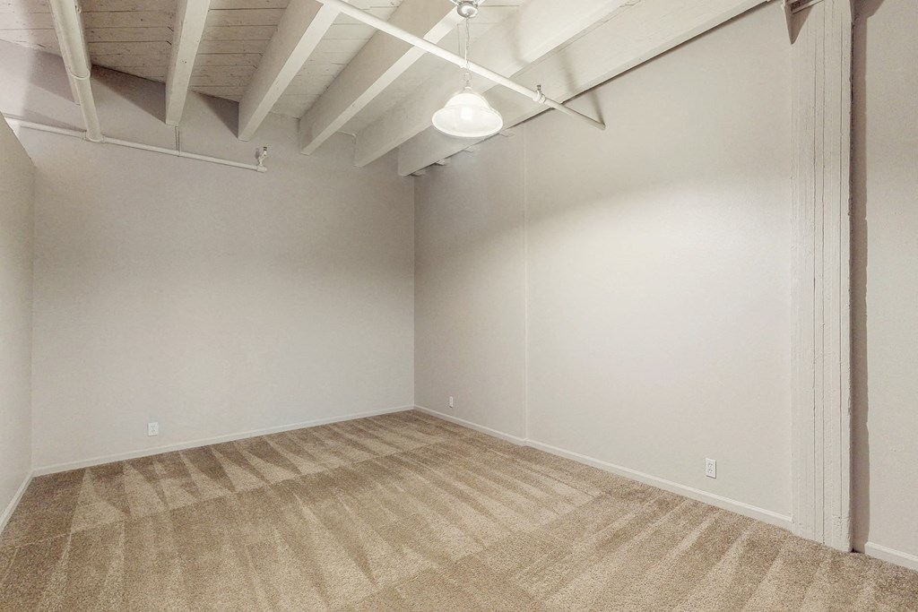 an empty room with a carpeted floor and white walls