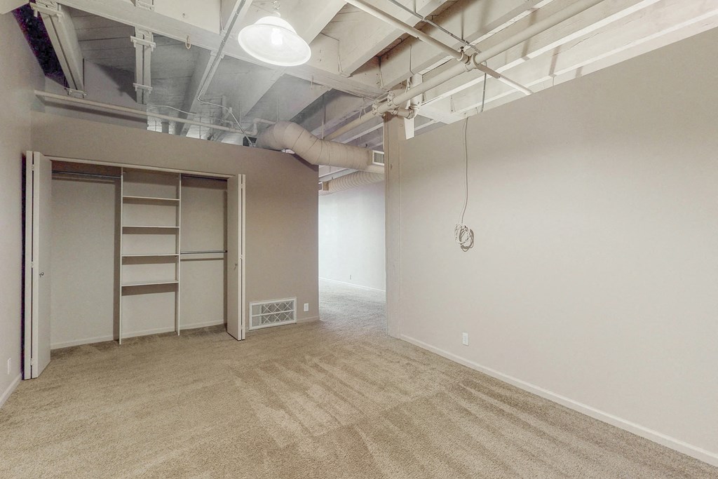 an empty room with a closet and a pull out bed