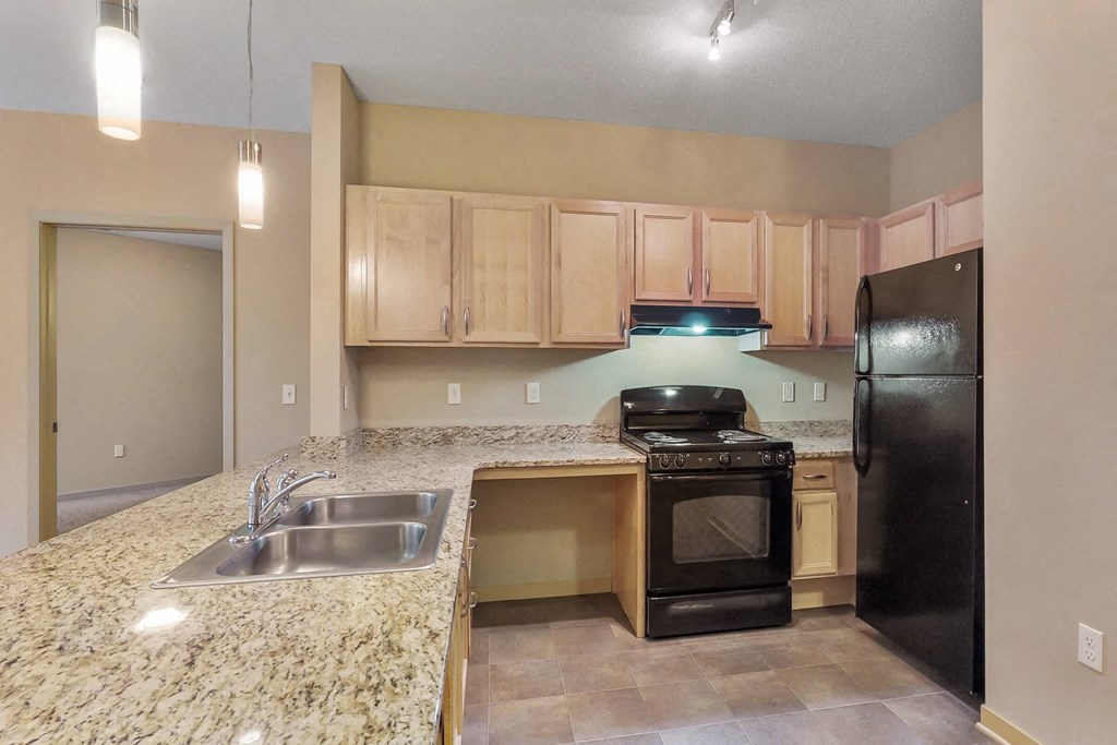 a kitchen with black appliances and granite counter tops