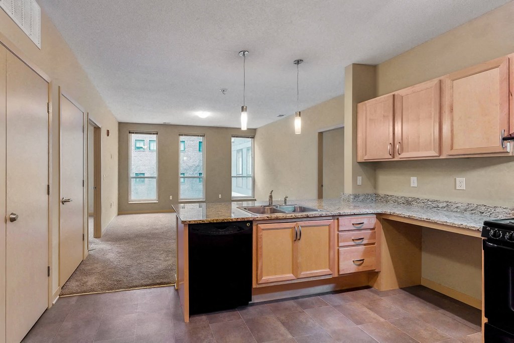 an empty kitchen with wooden cabinets and a sink