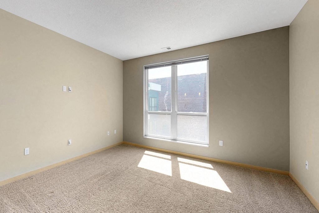 an empty living room with a large window