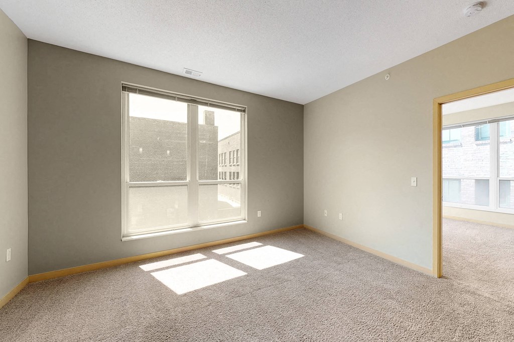an empty living room with a large window
