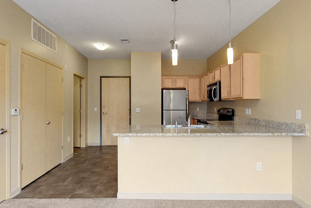 a kitchen with a counter top and a refrigerator