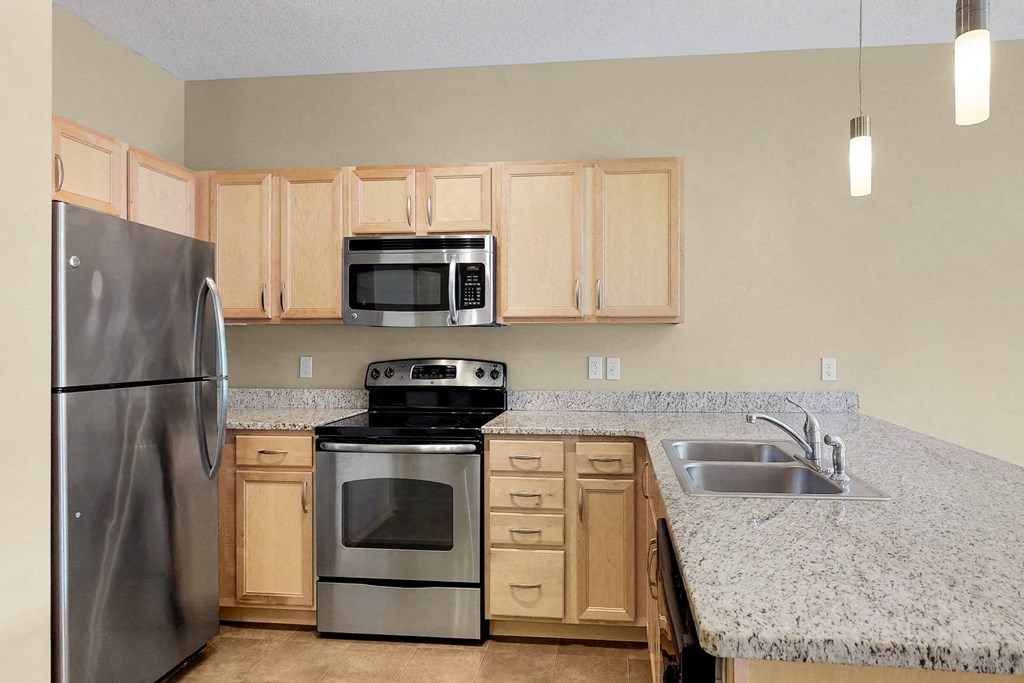 a kitchen with stainless steel appliances and granite counter tops