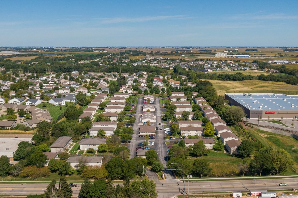 an aerial view of a suburb of a city with a solar installation on the roof