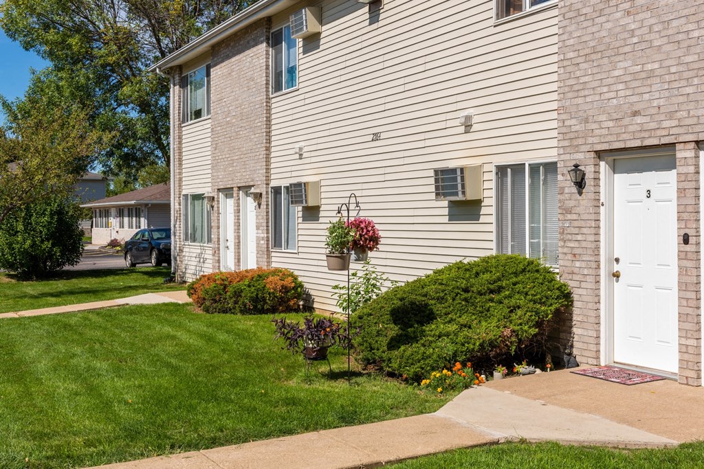 a side view of a white house with a white door
