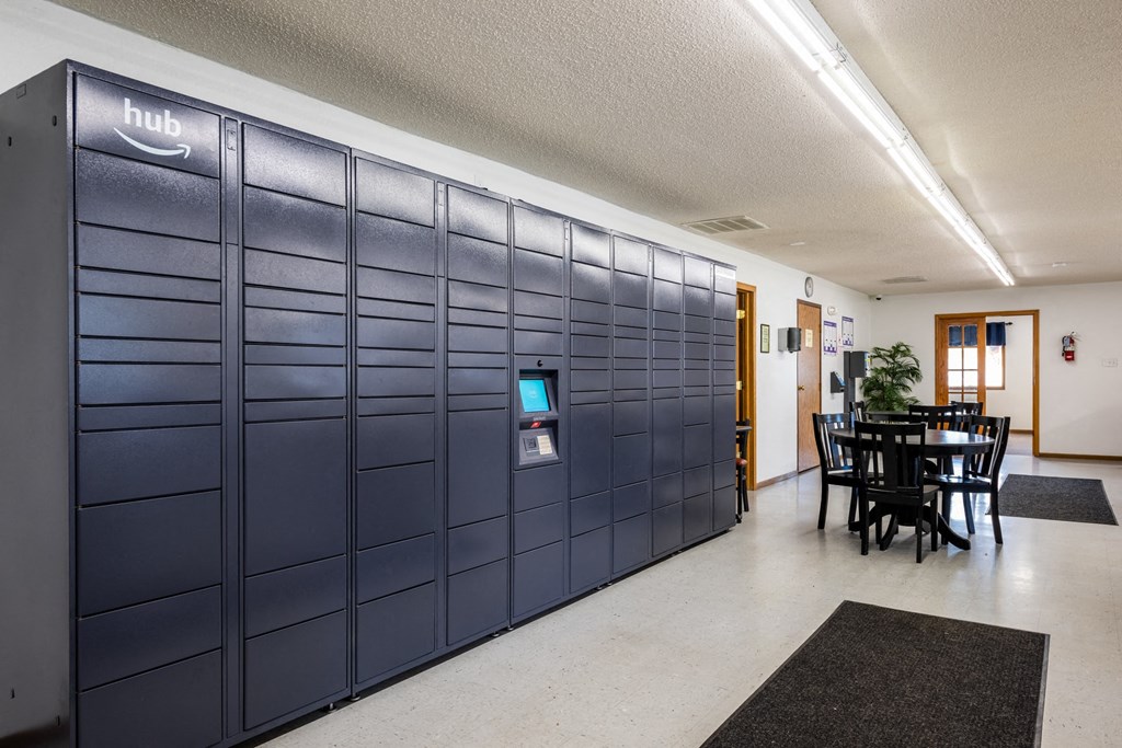 a set of lockers in a room with a table and chairs