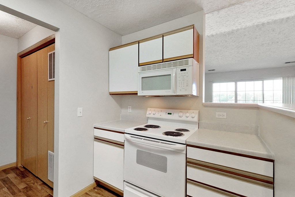 a kitchen with white appliances and white cabinets