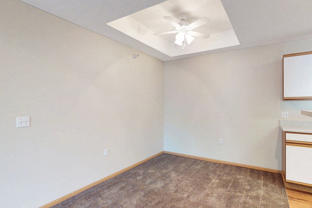 the living room of a home with a ceiling fan