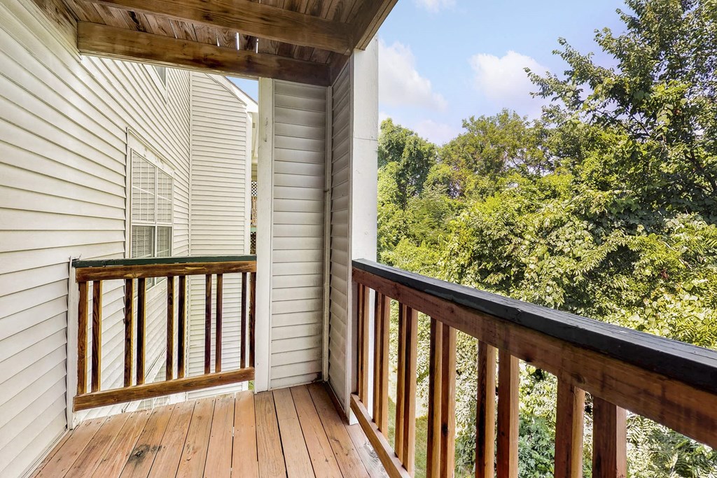 a balcony with a view of the woods