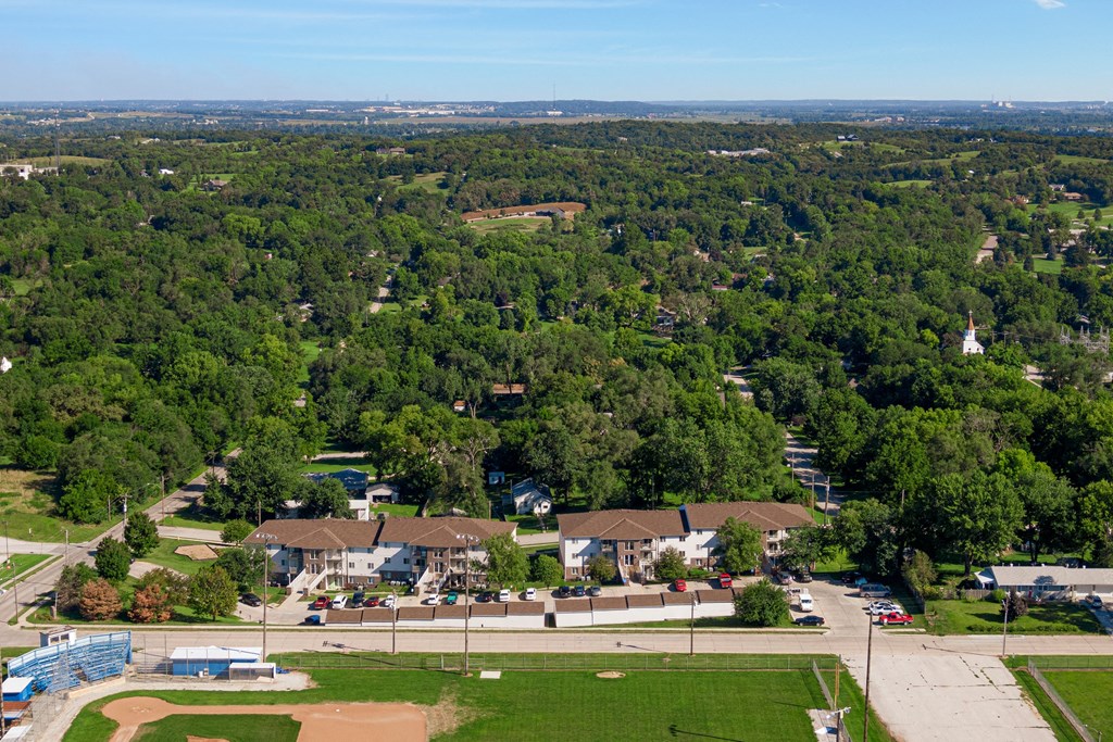 an aerial view of a neighborhood with houses and trees and a parking lot