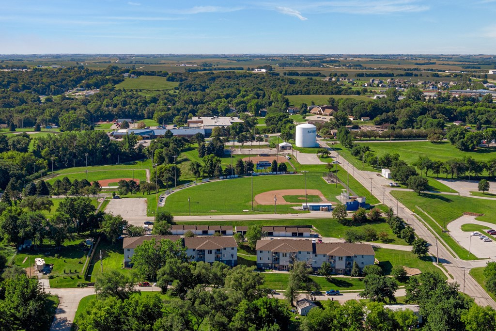 an aerial view of a park with houses and a water tower