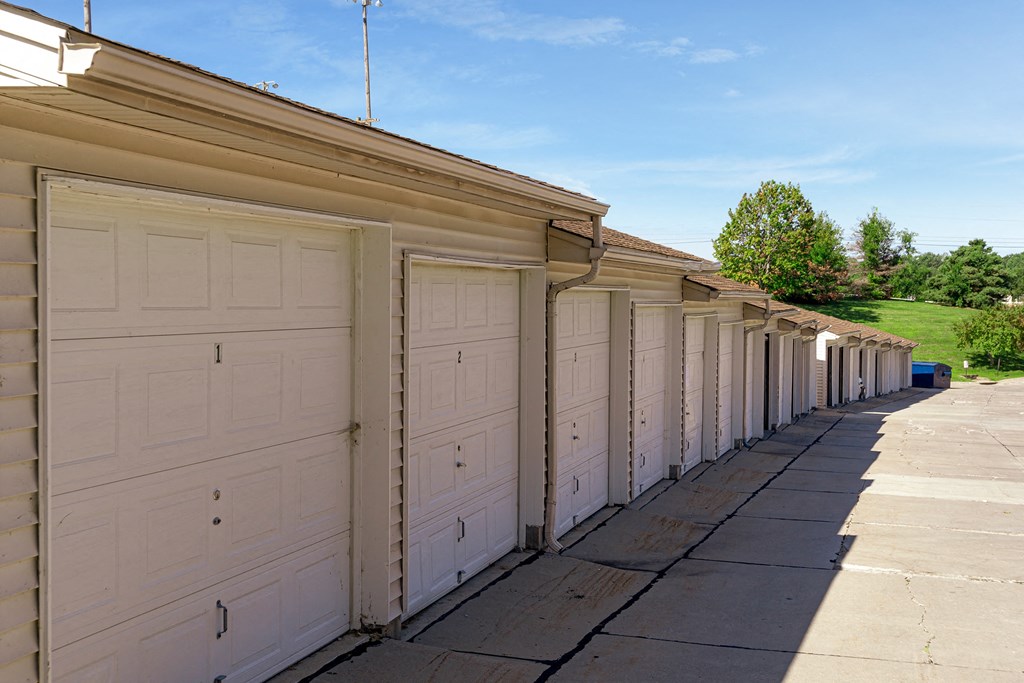 a row of garages with white garage doors