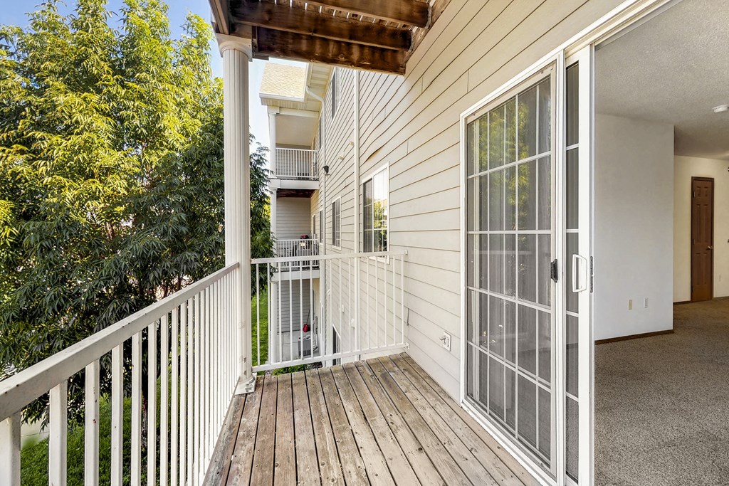 the deck of a home with a large glass door to the yard