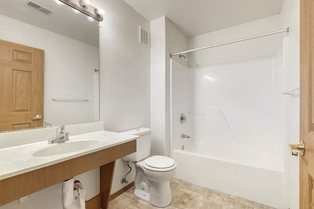 a bathroom with a sink toilet and a shower
