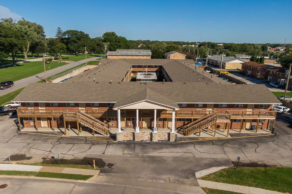 an aerial view of a building with wood framing and a covered porch