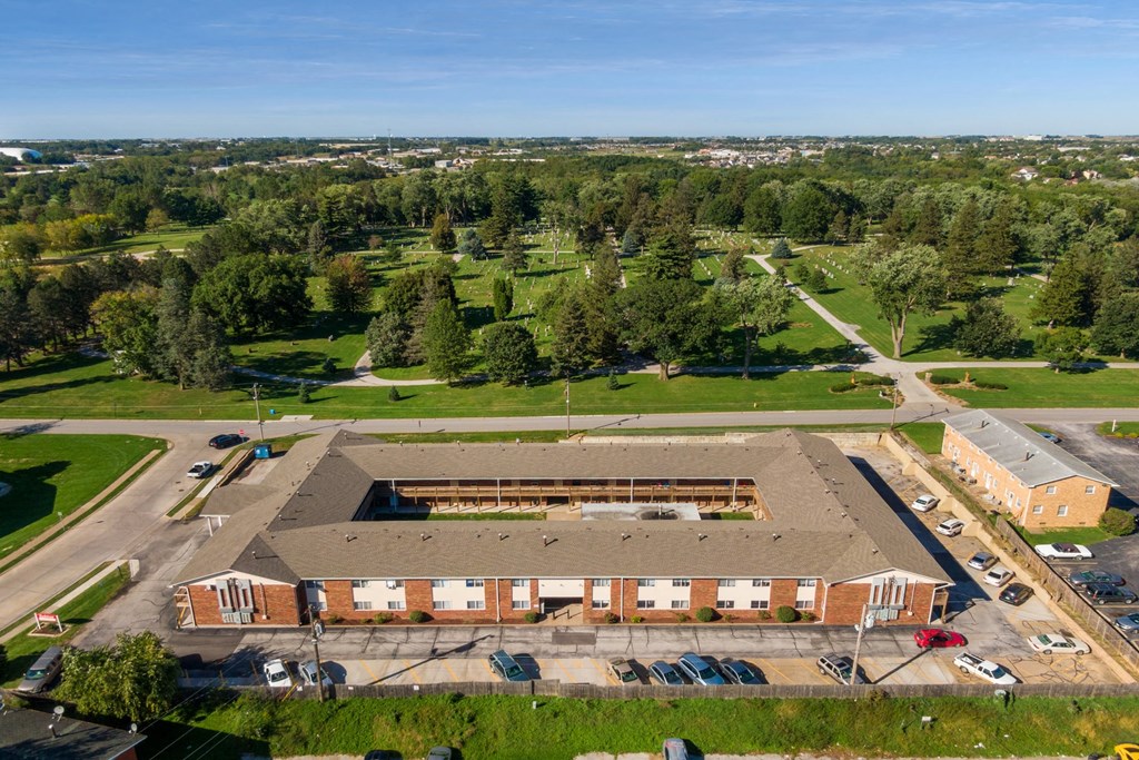 an aerial view of a large building in a parking lot