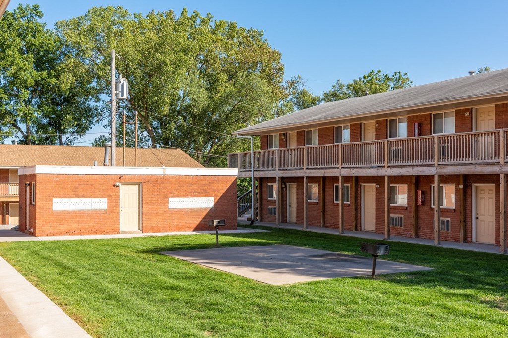 a building with a lawn and a flagpole in front of it