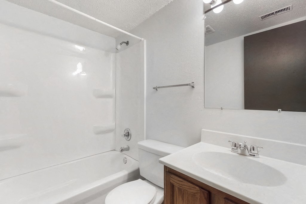 an empty bathroom with a sink toilet and shower