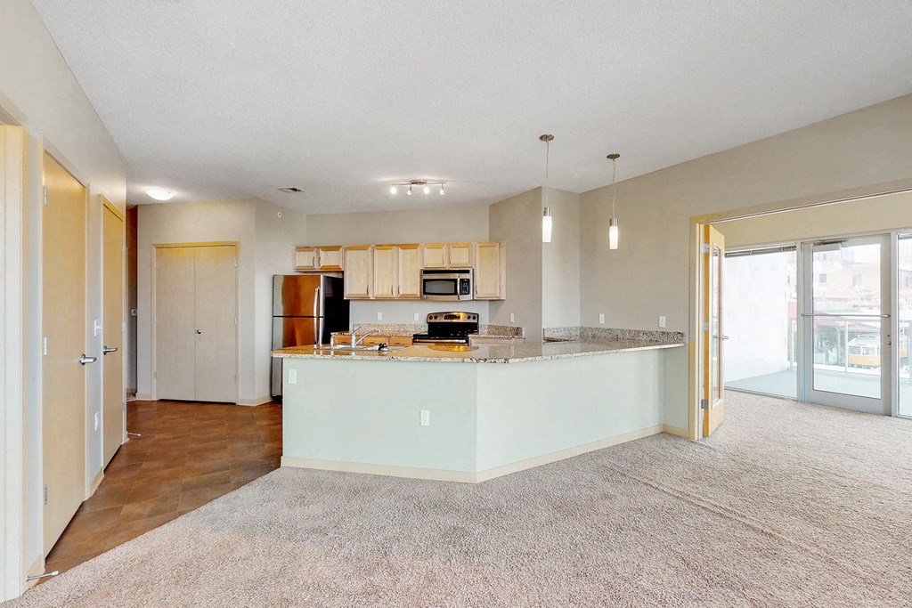 a kitchen with an island in the middle of a living room