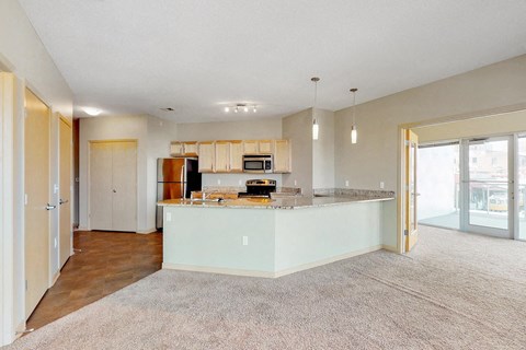 a kitchen with an island in the middle of a living room