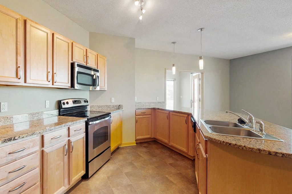a kitchen with wooden cabinets and a sink