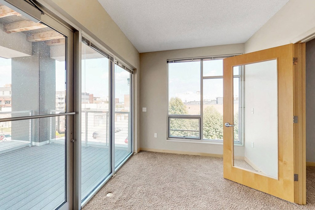 a living room with glass doors and a balcony