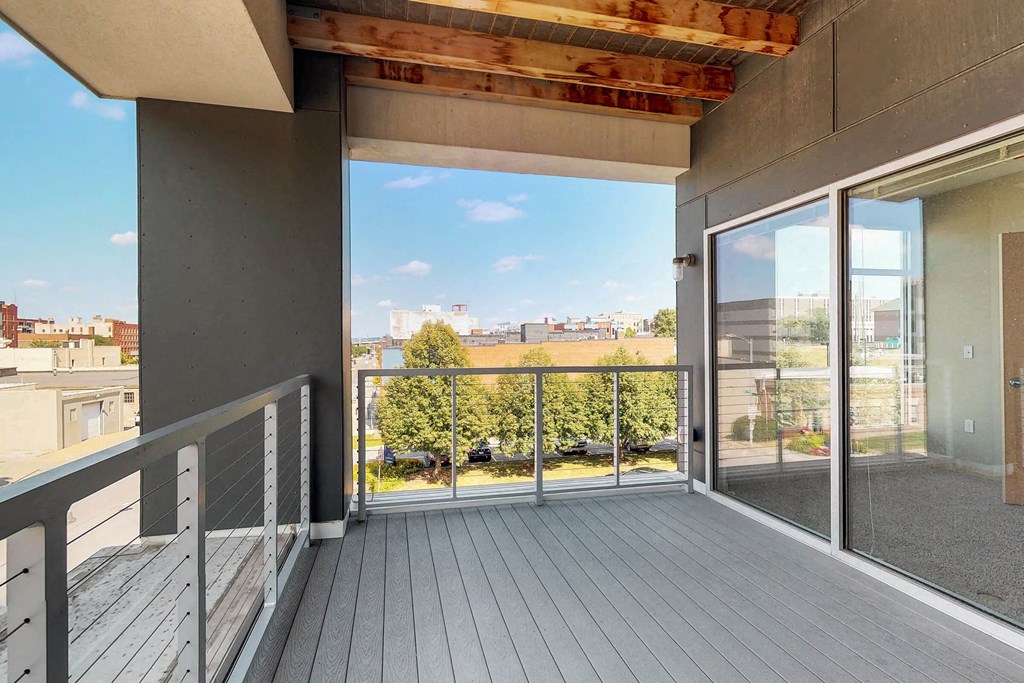 the view of the city from the balcony of an apartment