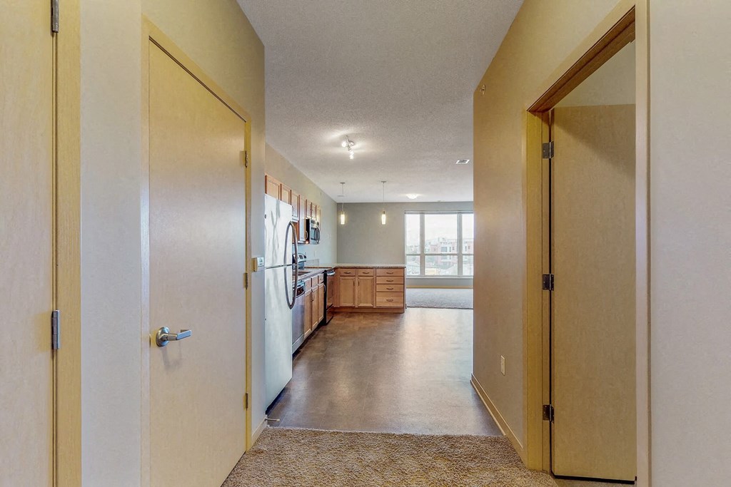 a view of a kitchen from a hallway with a door